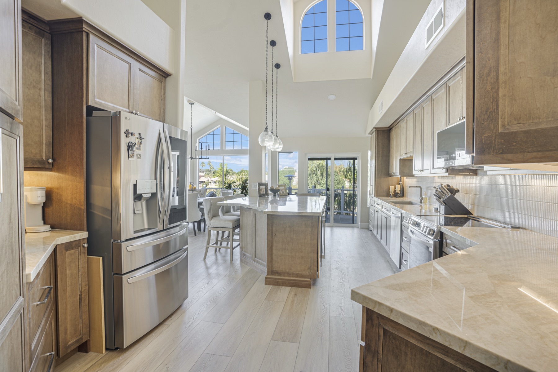 Open-concept kitchen remodel with quartz island and custom cabinetry