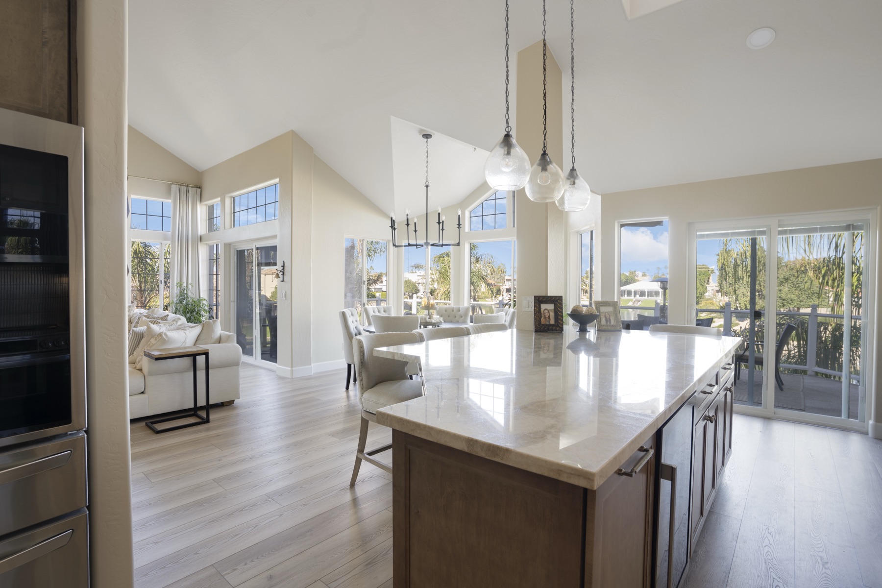 New quartz island with waterfall edge and refinished shaker cabinetry