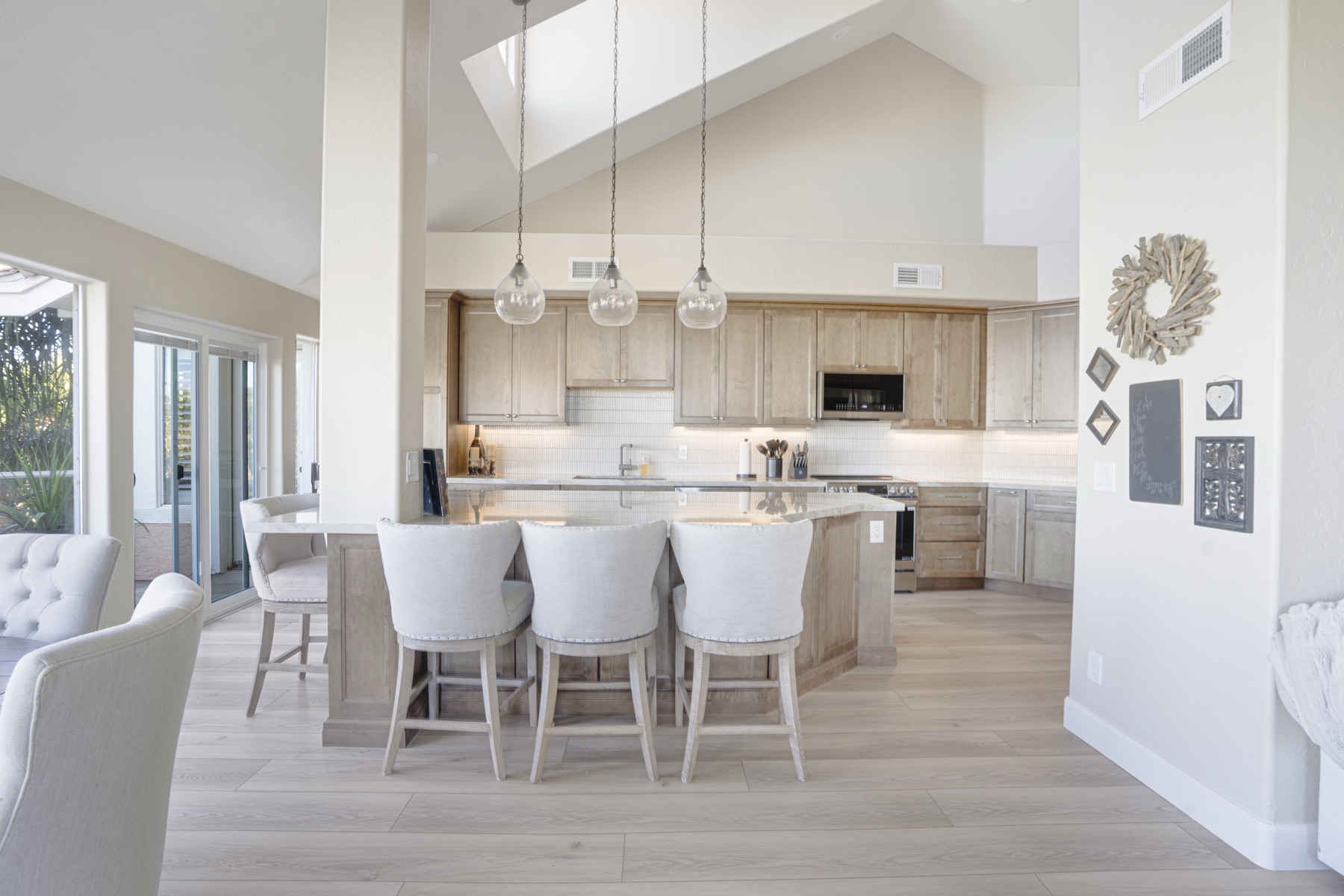 Kitchen with new pendant lighting, backsplash, and counters