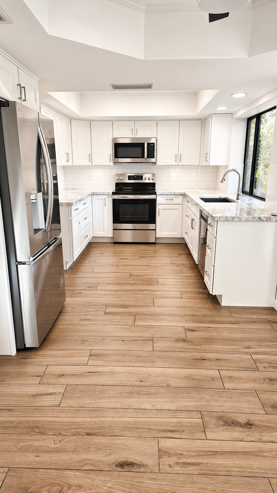 New wood-look tile flooring installed through a kitchen