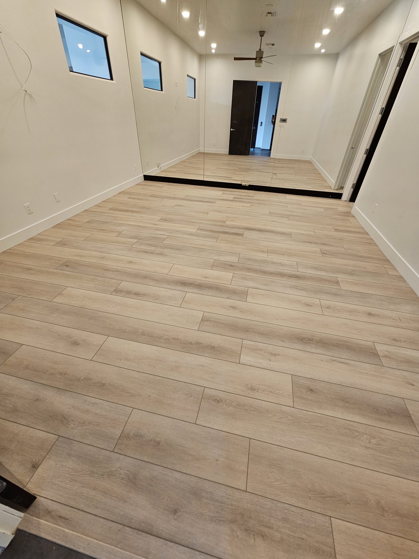 New wood-look tile flooring installed along a hallway
