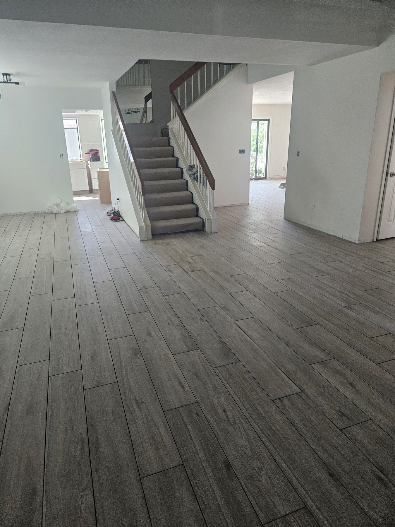 New wood-look tile flooring installed near a staircase