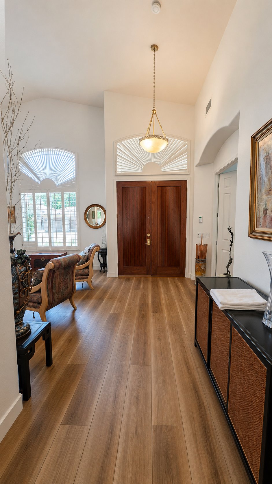New wide-plank flooring in a furnished home entryway and foyer