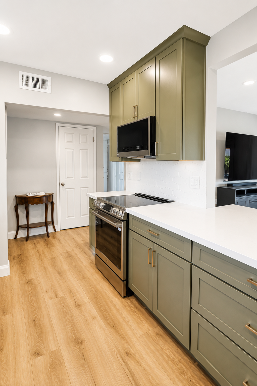 Finished range wall with olive cabinetry extending to the ceiling, quartz countertops, and under-cabinet lighting